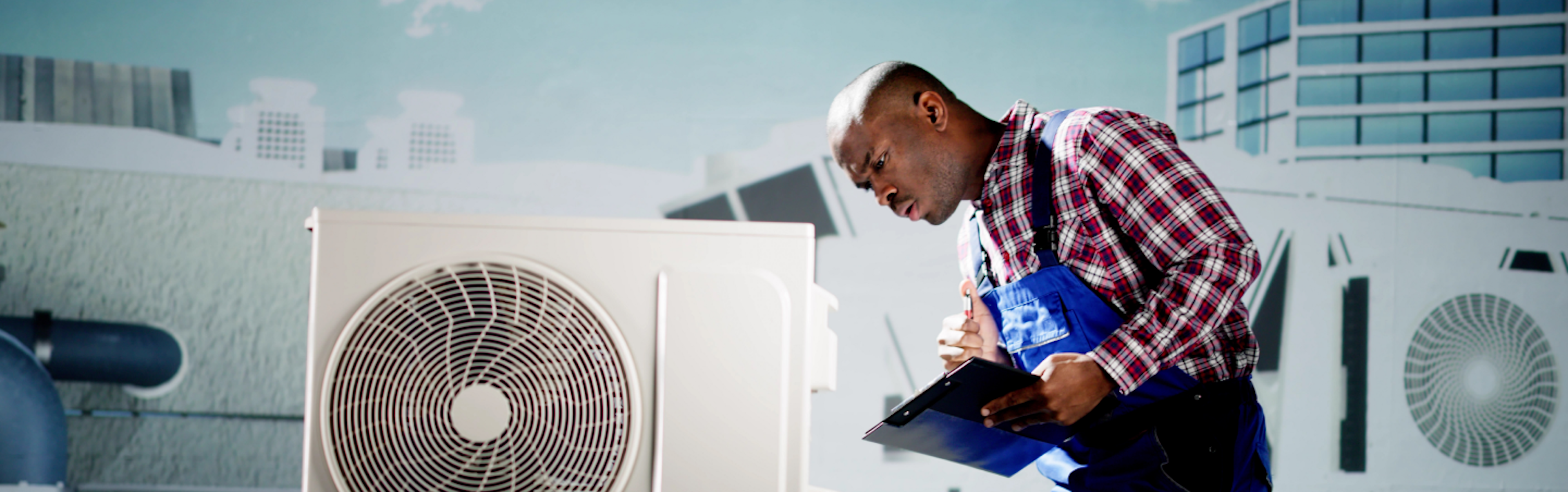 An individual in a plaid shirt holding a clipboard stands next to an outdoor air conditioning unit on a rooftop, with buildings in the background